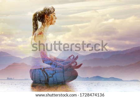 Double exposure of silhouette of woman doing yoga in lotus position over lake landscape. Concept of connection with the universe and nature.