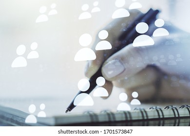 Double exposure of social network icons concept with man hand writing in notepad on background. Networking concept - Shutterstock ID 1701573847