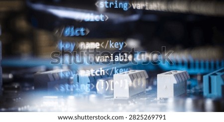 Double exposure of software code syntax and electronic components on a computer circuit board.