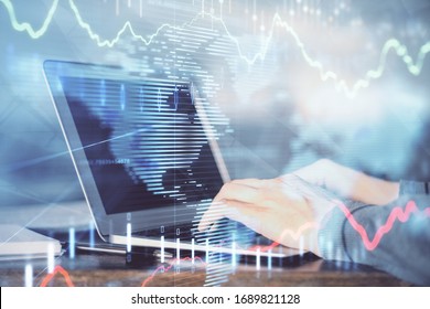 Double Exposure Of Stock Market Graph With Man Working On Laptop On Background. Concept Of Financial Analysis.