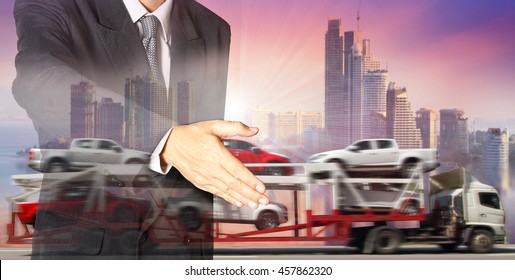 Double exposure of success businessman and blur motion of trailer transports cars on highway with big city background