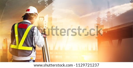 Double Exposure, Surveyor builder and engineer working with theodolite transit equipment at construction site outdoors in the city sunset background.