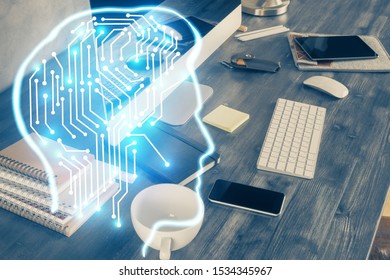 Double exposure of table with computer and brain hologram. Data innovation concept.