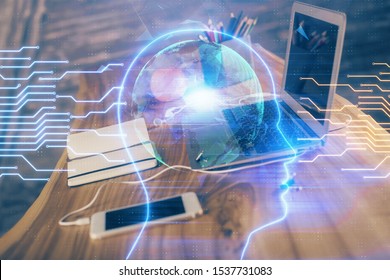 Double exposure of table with computer and brain hologram. Data innovation concept.