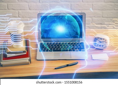 Double exposure of table with computer and brain hologram. Data innovation concept.