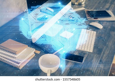 Double exposure of table with computer and brain hologram. Data innovation concept.
