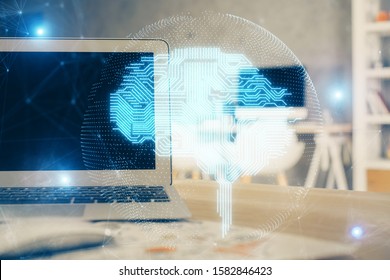 Double exposure of table with computer and brain hologram. Data innovation concept.
