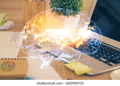 Double exposure of table with computer and brain hologram. Data innovation concept.