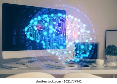 Double exposure of table with computer and brain hologram. Data innovation concept.