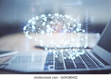 Double exposure of table with computer and brain hologram. Data innovation concept.