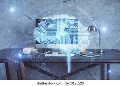 Double exposure of table with computer and brain hologram. Data innovation concept.