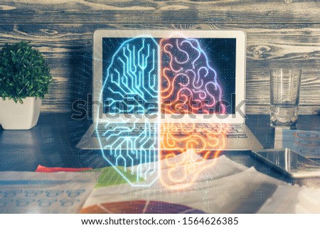 Double exposure of table with computer and brain hologram. Data innovation concept.