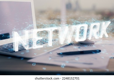 Double exposure of table with computer on background and data theme hologram. Data technology concept.