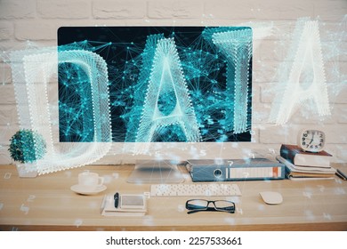 Double exposure of table with computer on background and data theme hologram. Data technology concept.