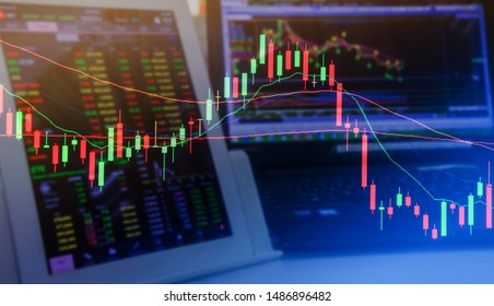 Double exposure. Technical candlestick price chart, up and down trend, volatility, panic sell, red selling stock ticker trading data on computer screen background. Economic and business crisis concept