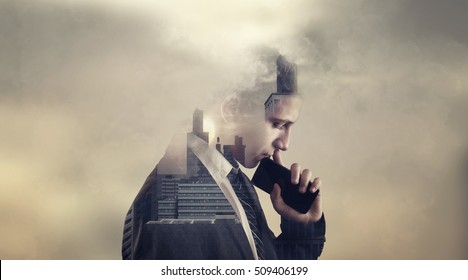 Double exposure of a thoughtful bussinessman with a phone and a city view suggesting a very important decision.