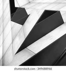 Double exposure tilt photo of walls consisting of rectangular white and black panels after digital alteration which transformed snapshots into notable architecture project resembling shelves on slopes