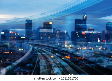 Double exposure train track with blurred light city office building, night view, abstract background