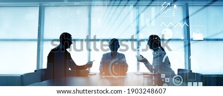 Double exposure of virtual screen and colleagues at business meeting in office