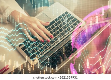 Double exposure of woman hands typing on computer and financial graph hologram drawing. Stock market analysis concept.
