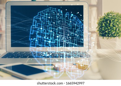 Double exposure of work space with computer and human brain drawing hologram. Brainstorm concept.