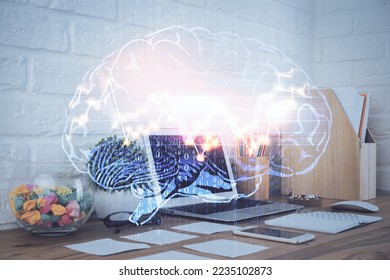 Double exposure of work space with computer and human brain drawing hologram. Brainstorm concept.