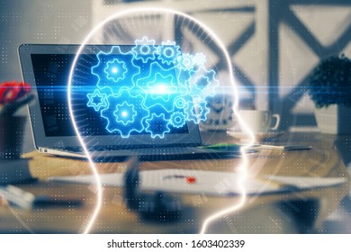 Double exposure of work table with computer and brain sketch hologram. Brainstorming concept.