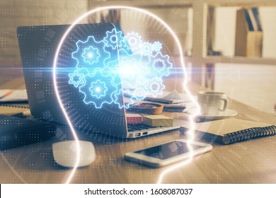 Double exposure of work table with computer and brain sketch hologram. Brainstorming concept.