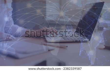Double exposure of world map hologram with man working on computer on background. Concept of worldwideweb.