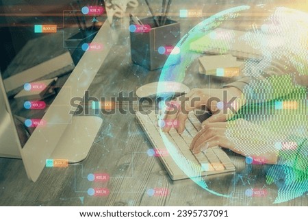 Double exposure of world map hologram with man working on computer on background. Concept of worldwideweb.