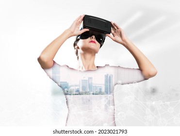 Double Exposure Of Young And Beautiful Woman In Red Dress Using Virtual Reality Headset While Standing Indoors Of Office Building With Digital Network Structure.