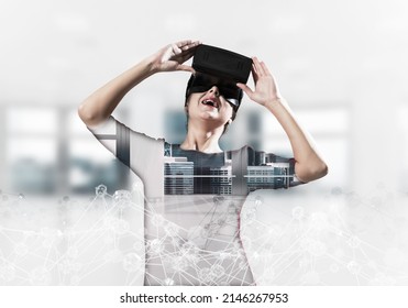 Double Exposure Of Young And Beautiful Woman In Red Dress Using Virtual Reality Headset While Standing Indoors Of Office Building With Digital Network Structure.