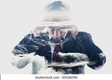 Double Exposure Of  A Young Business Man Looking Depressed From Work, Relaxed Mountain Winter Landscape In Background