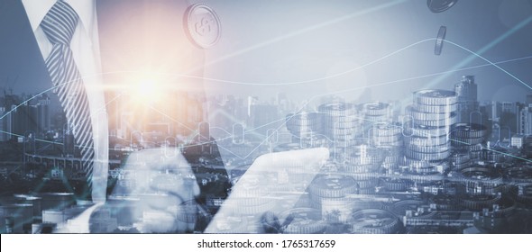 Double exposure-businessman use tablet,cityscape and stack coin,graph stock chart,concept financial,banking business,saving, investing,real estate,debt instruments,finance and foreign exchange trading - Powered by Shutterstock