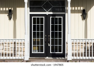 Double French Doors With Porch, Pale Yellow Siding And White Trim