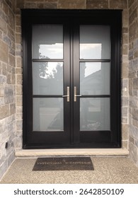 Double Front Entry door with Sandblasted Glass and SDL grills, black aluminum exterior with stone exterior