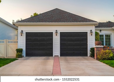Double garage with short driveway in day - Shutterstock ID 1552022531