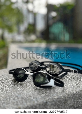Double goggles next to the pool