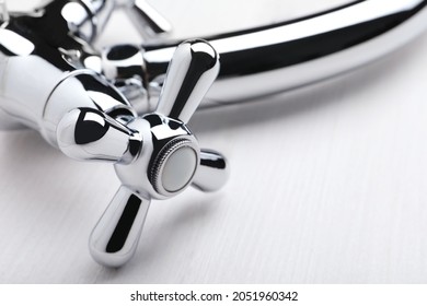 Double Handle Water Tap On White Wooden Table, Closeup