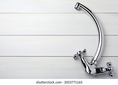 Double Handle Water Tap On White Wooden Table, Top View. Space For Text