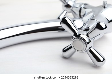 Double Handle Water Tap On White Wooden Table, Closeup