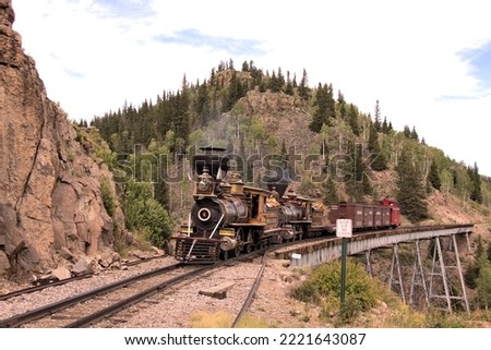 A Double Header of Two Rare Steam Locomotives Pulling a Freight Train over a Steel Bridge