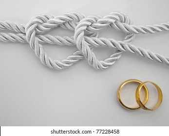 Double heart shaped silver rope tied and a double gold ring