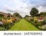 Double herbaceous borders with profusion of flowering perennial plants in the height of summer.