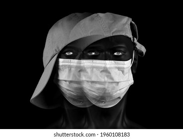 Double Image Of Dark Plastic Mannequin Head With Clear Eyes, Face Mask, And Cap With Visor, Black Background, Monochrome Photo