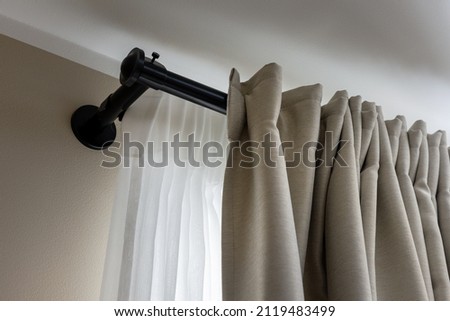 double layer curtains on black rod in living room