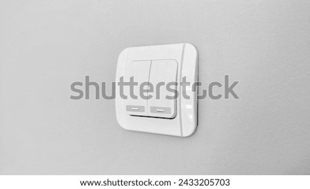Double light switch on gray wall