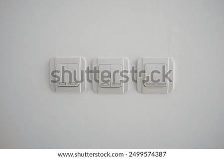 Double light switch on gray wall