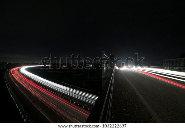 Double long\
exposure effects on highway during a dark night with trailing\
effects of vehicle head lamps and tail\
lamps.