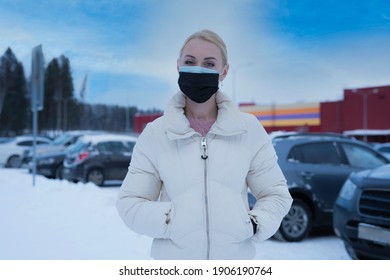 Double Mask On The Face. A Woman Wearing Two Medical Masks At The Same Time, Blue And Blue